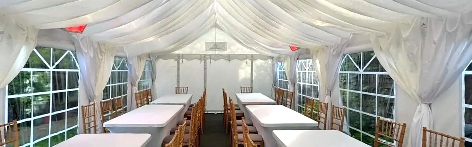 Marquee Event Planning Setup With Long Tables Marquee interior with long table layout and chairs arranged for event planning