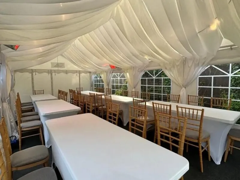 marquee-corporate-long-table-dining-essex Ivory draped marquee with long dining tables and chiavari chairs arranged for event seating