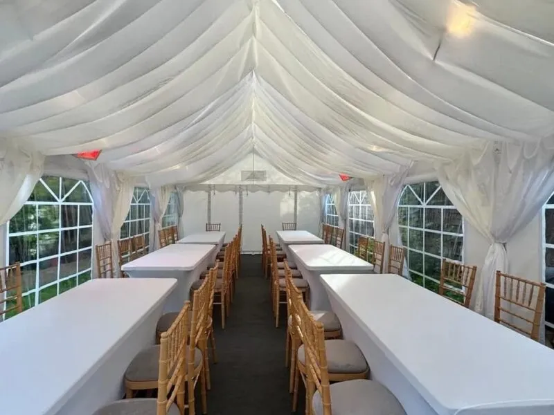 marquee-event-symmetrical-table-layout-essex Ivory draped marquee with symmetrical long table dining layout and chiavari chairs