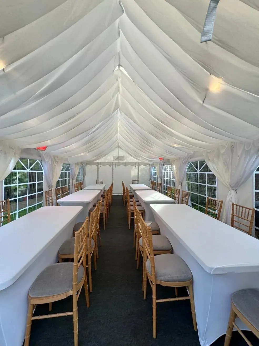 marquee-event-symmetrical-table-layout-essex Ivory draped marquee with symmetrical long table dining layout and chiavari chairs