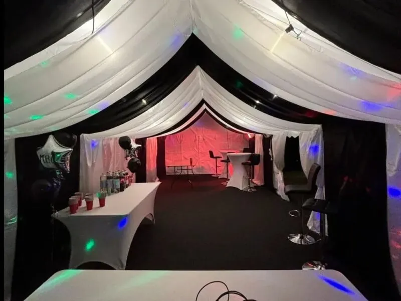 Party marquee with bar setup, drinks table and coloured lighting