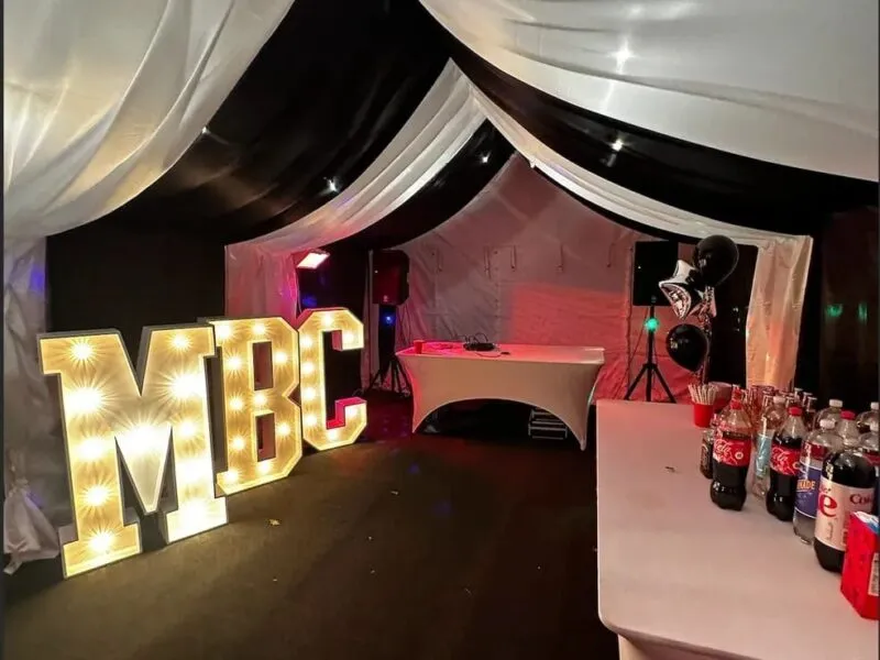 Party Marquee With DJ And Light Up Letters Party marquee with DJ booth, drinks table and illuminated light up letters