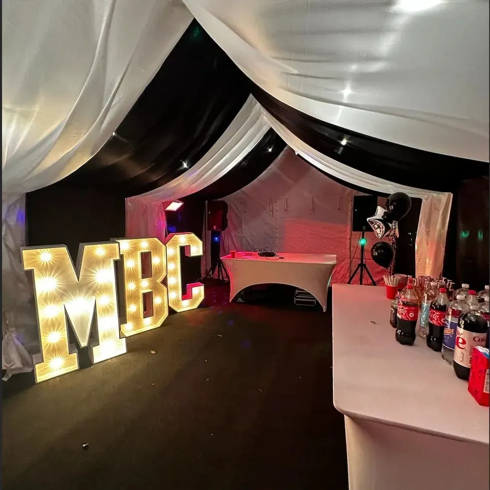 Party Marquee With DJ And Light Up Letters Party marquee with DJ booth, drinks table and illuminated light up letters