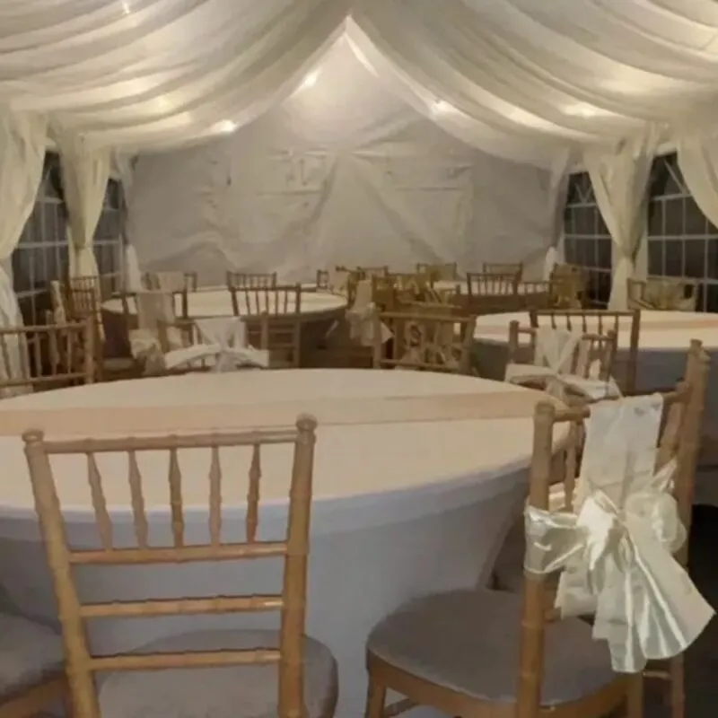 Marquee Event Setup And Hire Services Essex Marquee interior with round tables and chairs set up for event hire in Essex