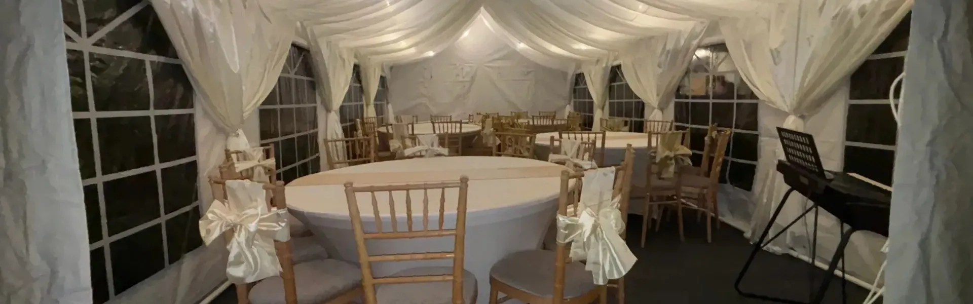 Marquee Event Setup And Hire Services Essex Marquee interior with round tables and chairs set up for event hire in Essex