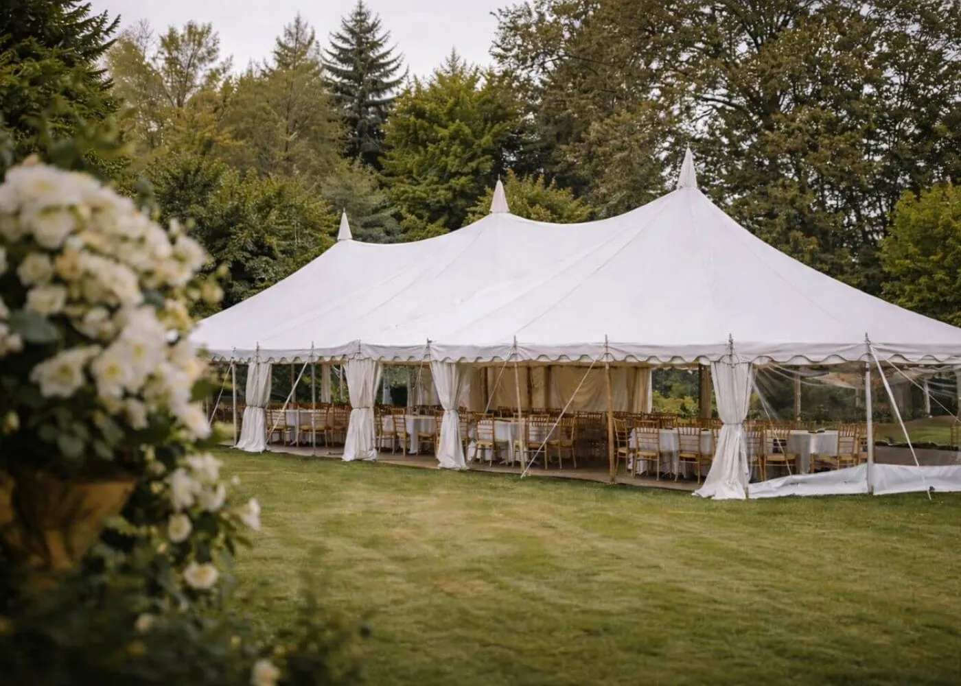 Traditional Marquee Event Setup Essex Traditional marquee setup in garden with tables and seating ready for event