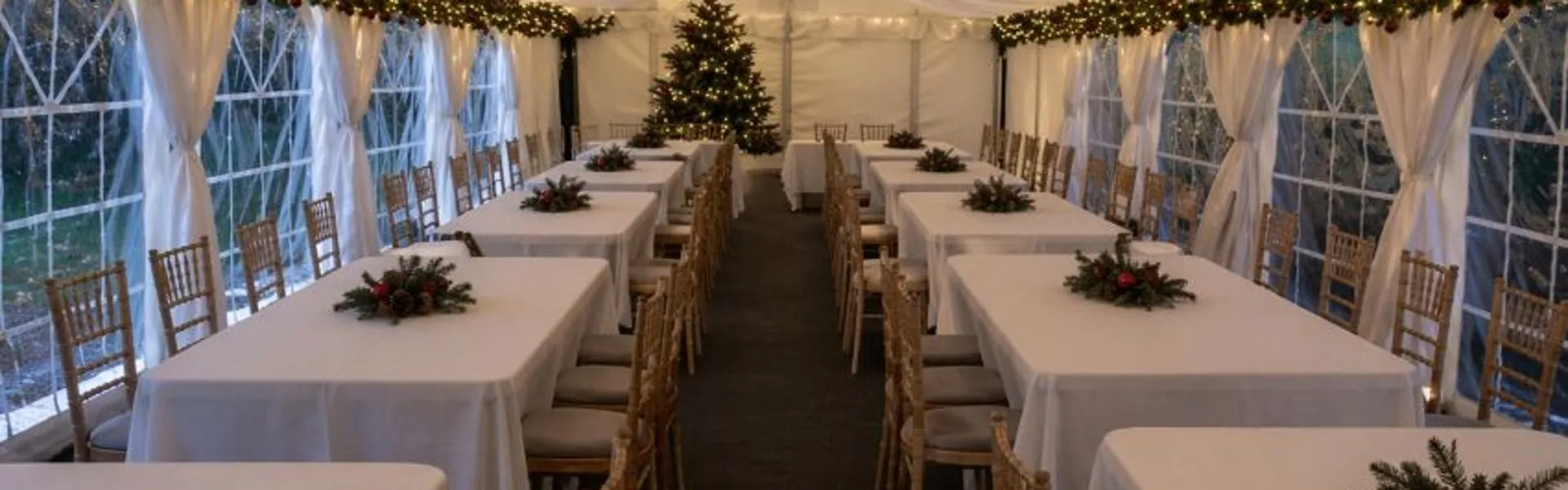 Christmas marquee banquet layout with spaced tables and festive lighting for events in Essex