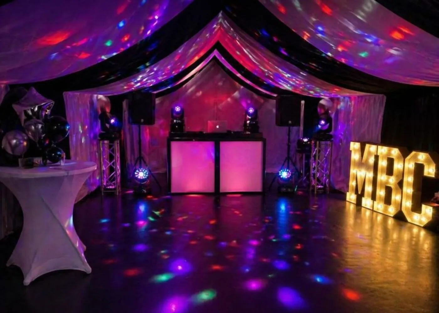 DJ Hire Essex – Marquee Party DJ and Lighting Setup DJ hire setup in Essex marquee with lighting, speakers and illuminated letters for party event