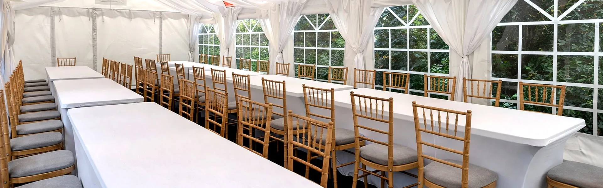 Furniture Hire Long Table And Chair Layout Marquee interior with long tables and Chiavari chairs arranged for furniture hire setup