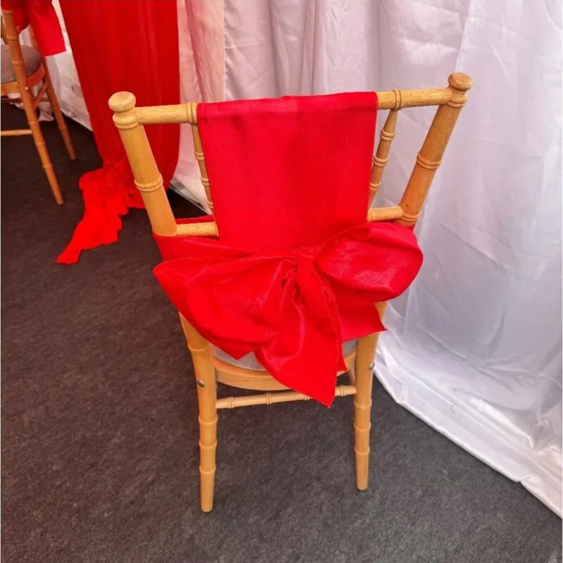 Chair Bow Detail – Forest Gate Marquee Setup Chiavari chair with red bow detail inside marquee in Forest Gate during family event setup
