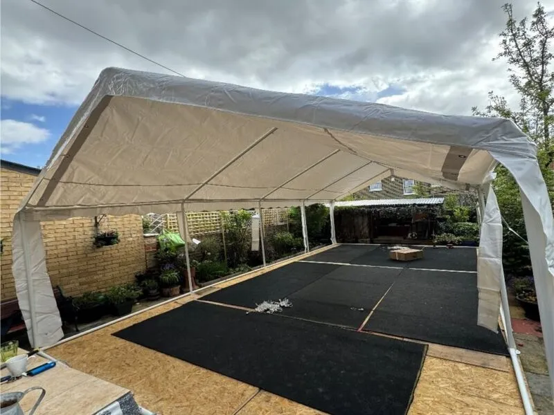 Marquee Structure Installation – Forest Gate Garden Setup 4m x 8m marquee structure installation in Forest Gate garden with flooring and frame setup in progress