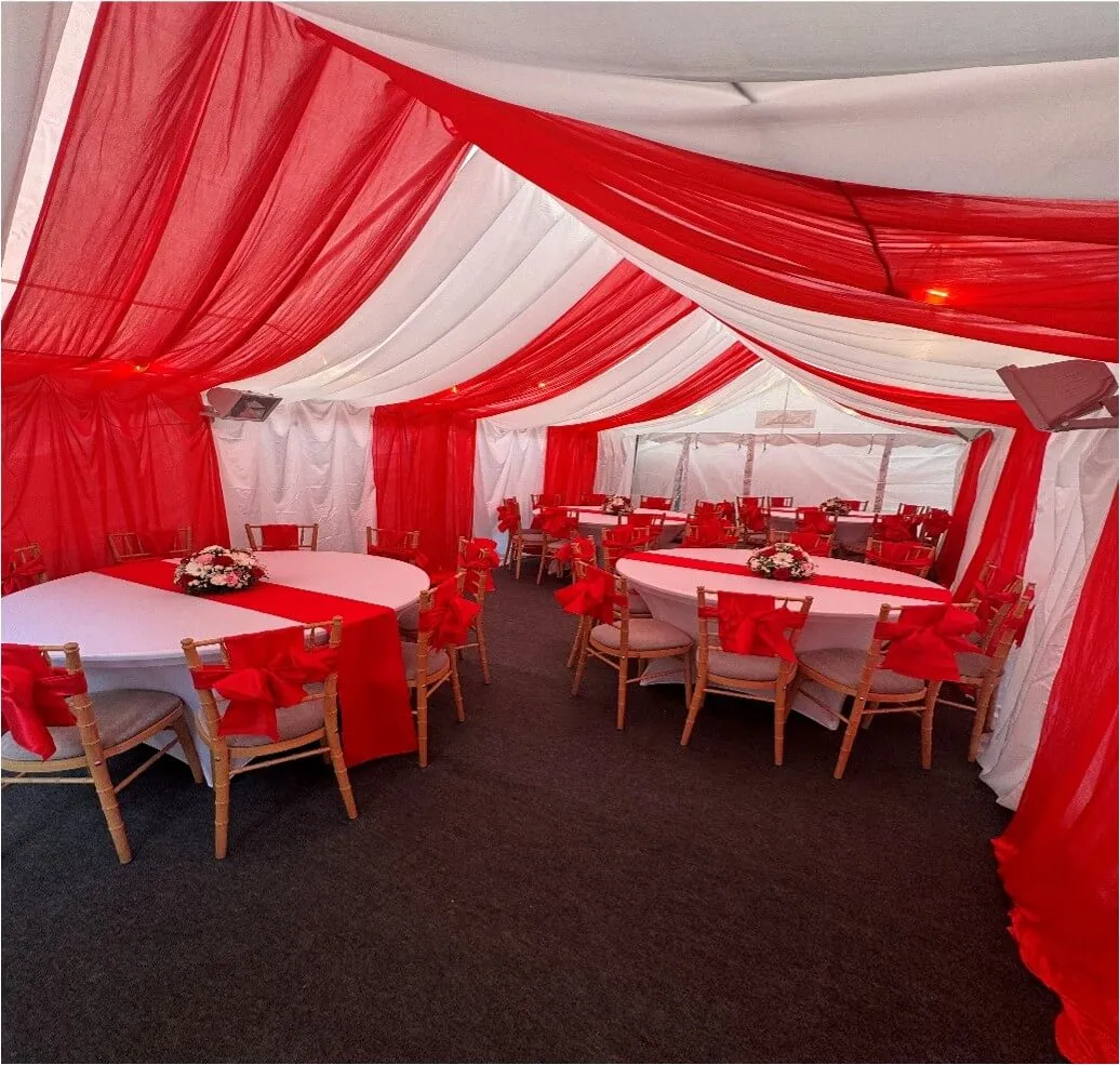 Red Themed Round Table Setup – Forest Gate Marquee Interior 4m x 8m marquee interior in Forest Gate with red and white draping, round table layout and Chiavari chairs for family celebration