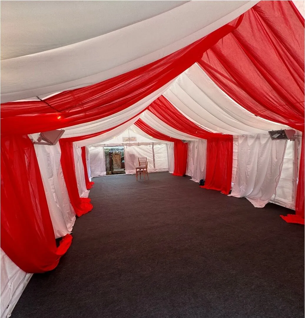 Red Themed Marquee Interior – Forest Gate Event Setup 4m x 8m marquee interior in Forest Gate with red and white draped lining, round table layout and Chiavari chairs for family event