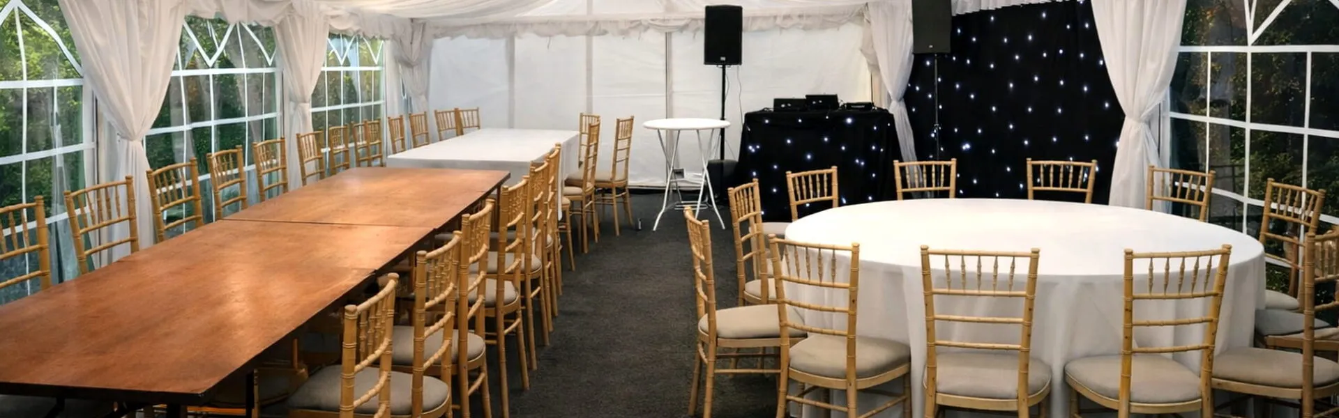 marquee-case-studies-layout-hero Marquee interior with long tables, round tables and DJ setup showing real event case study layout