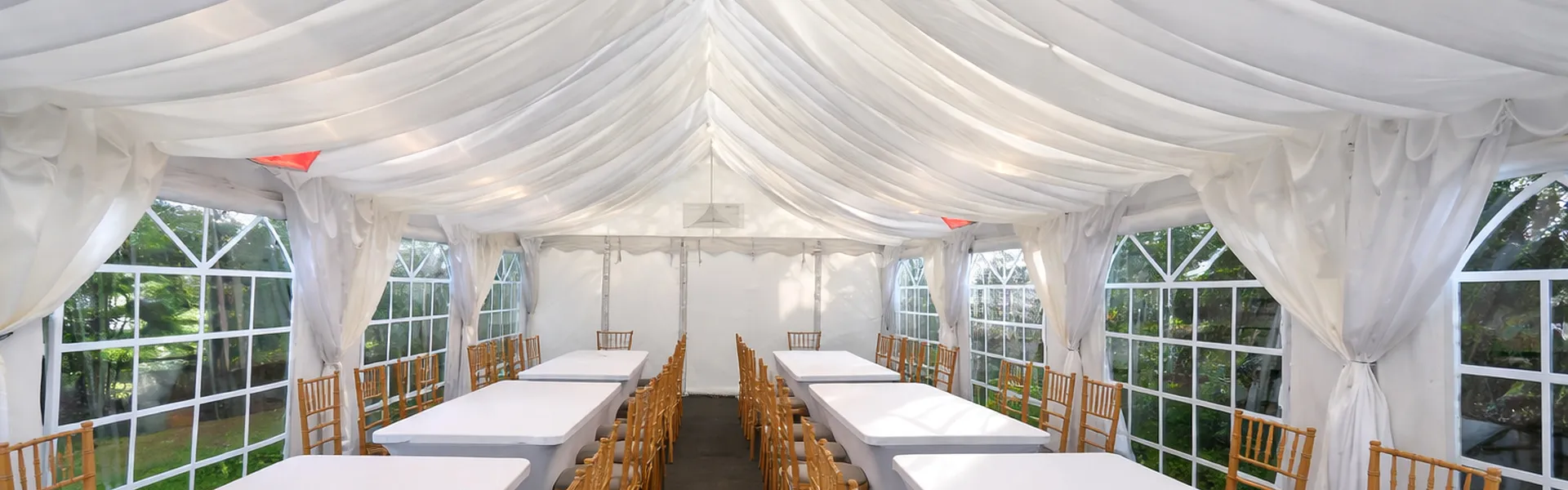 Marquee Corporate Event Layout With Long Tables Essex Marquee interior with long table layout and chairs arranged for corporate event setup and planning in Essex