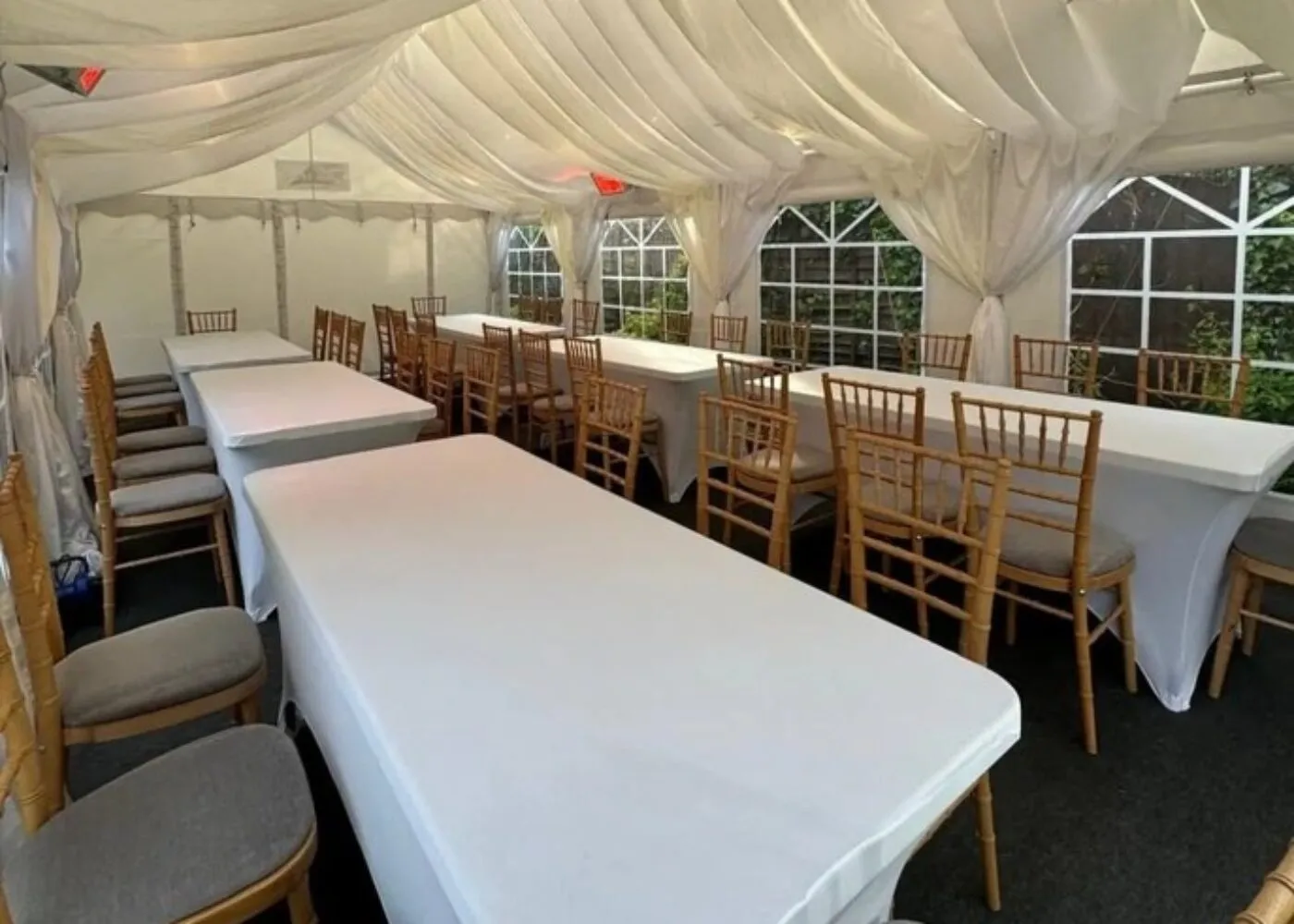 Chair Hire Essex – Event Seating Layout with Chiavari Chairs Limewash Chiavari chair hire in Essex arranged in long table seating layout inside marquee