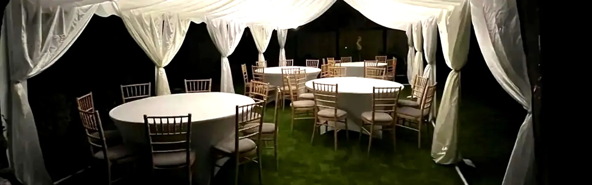 Marquee Evening Event Setup With Round Tables Evening marquee setup with round tables and chairs arranged for event