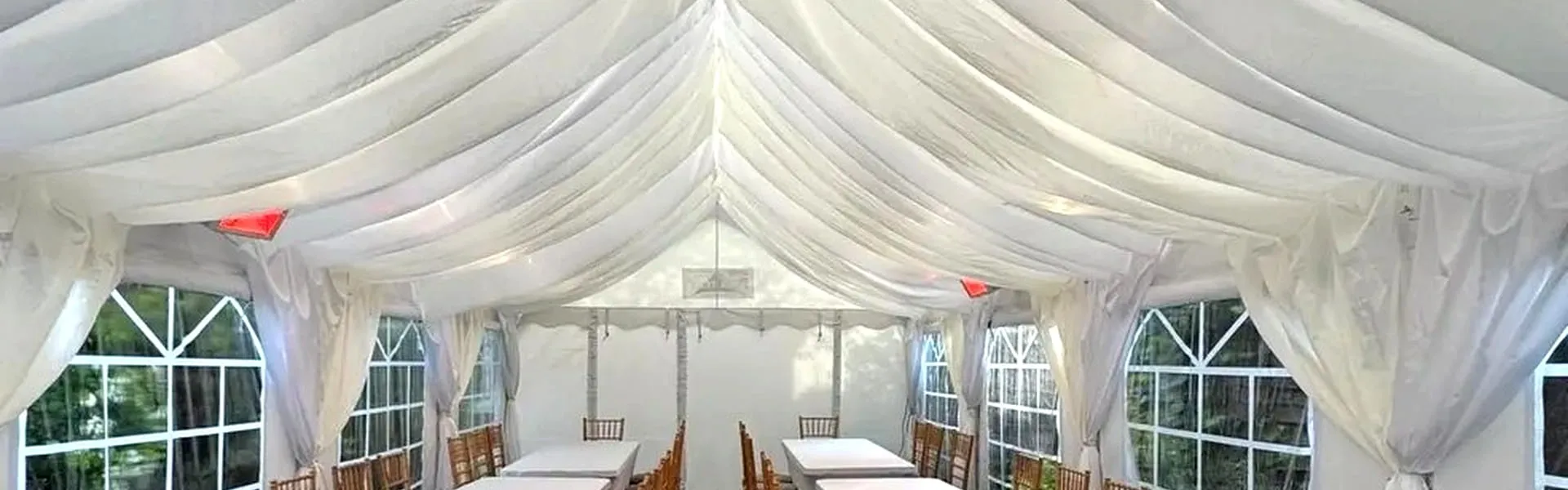 Marquee Event Layout With Long Tables And Chairs Marquee interior with long table layout and chairs arranged for event setup