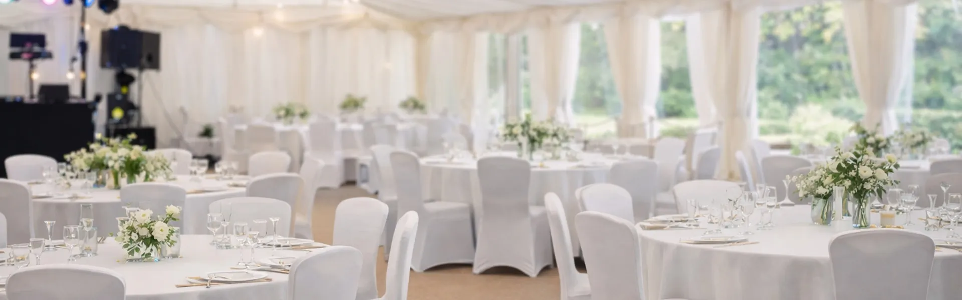 Marquee Event Planning Setup Marquee interior with standard chairs, tables and DJ setup for event planning and hire in Essex