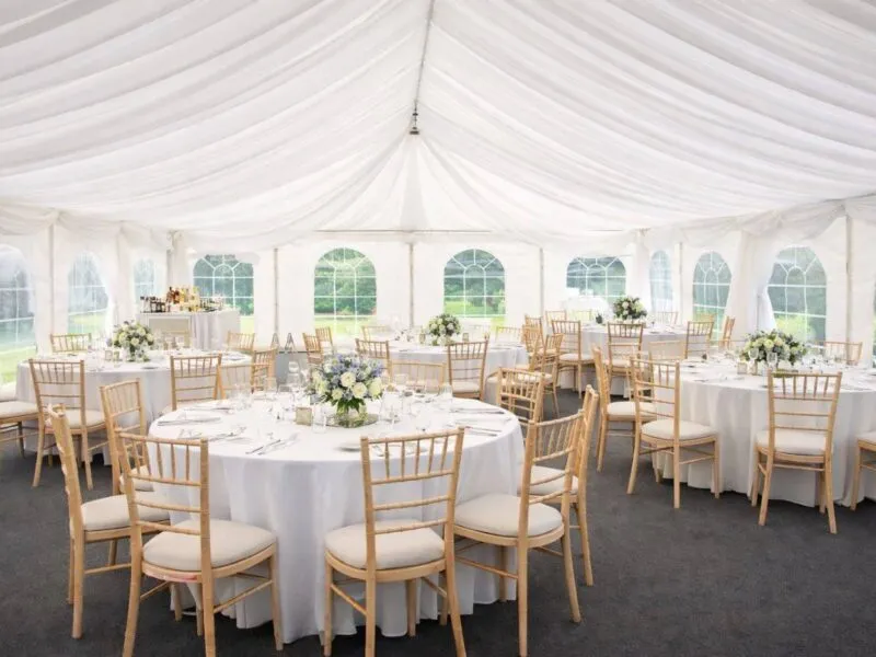 Marquee Event Setup For Quote And Planning Marquee interior with round tables and chairs arranged for event planning and hire