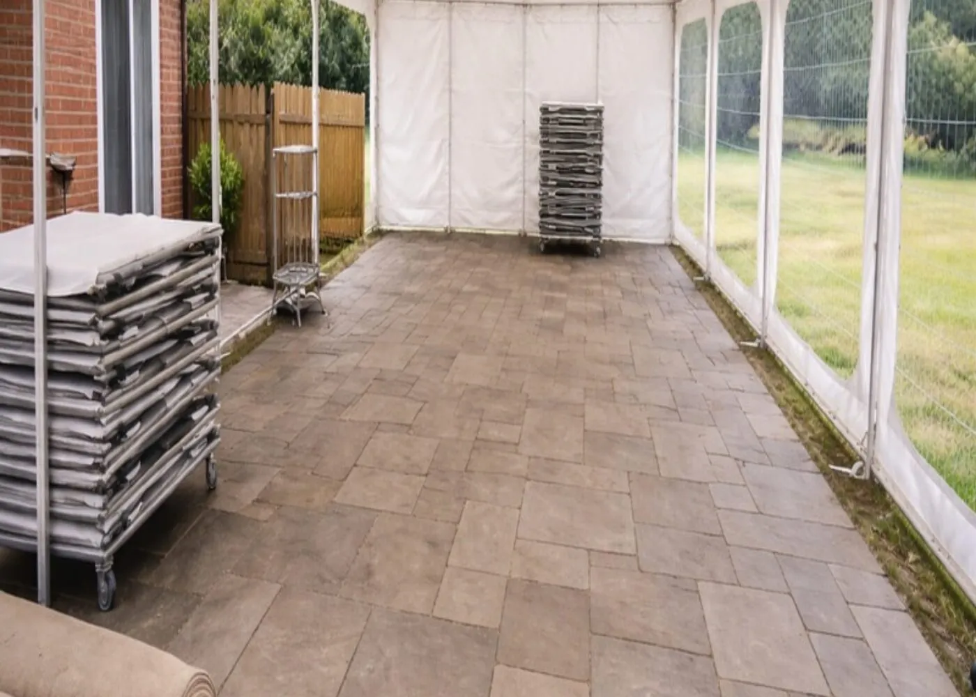 Marquee Flooring Setup Essex – Event Preparation and Installation Marquee setup in Essex showing flooring installation and stacked equipment ready for event preparation