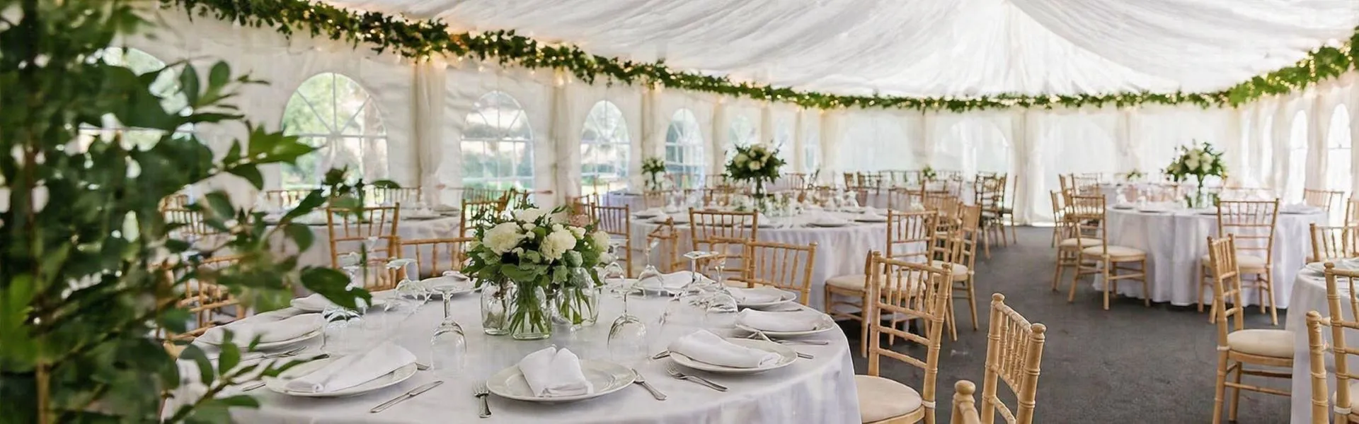 Marquee Hire Essex – Round Table Event Setup Marquee hire in Essex with round table layout, Chiavari chairs and draped interior for private event setup