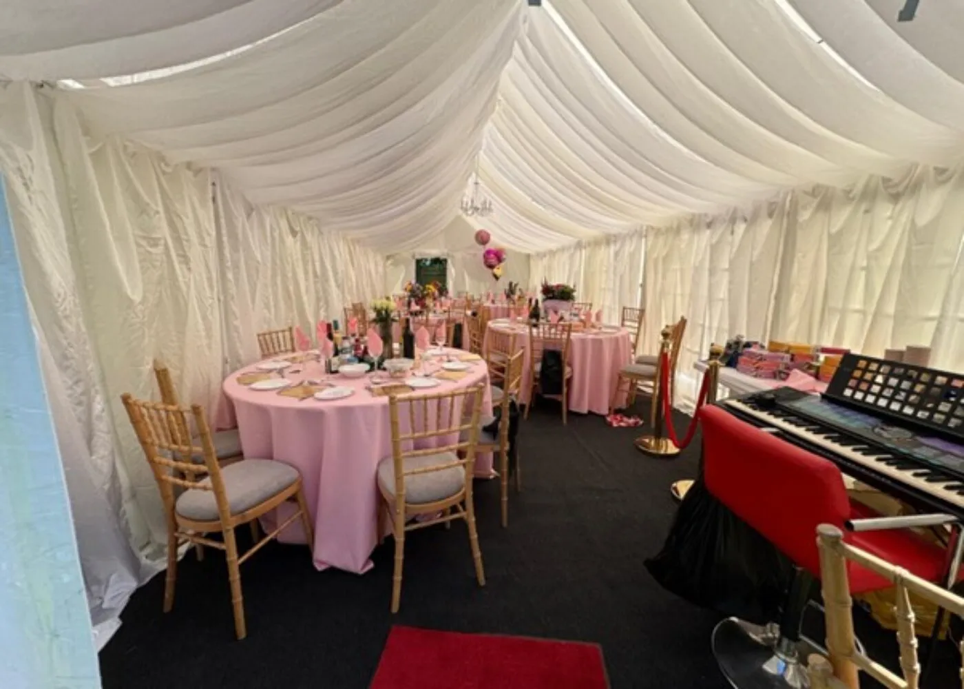 Marquee Interior Dining Setup Hainault Marquee interior with round tables, Chiavari chairs and lighting for birthday celebration in Hainault