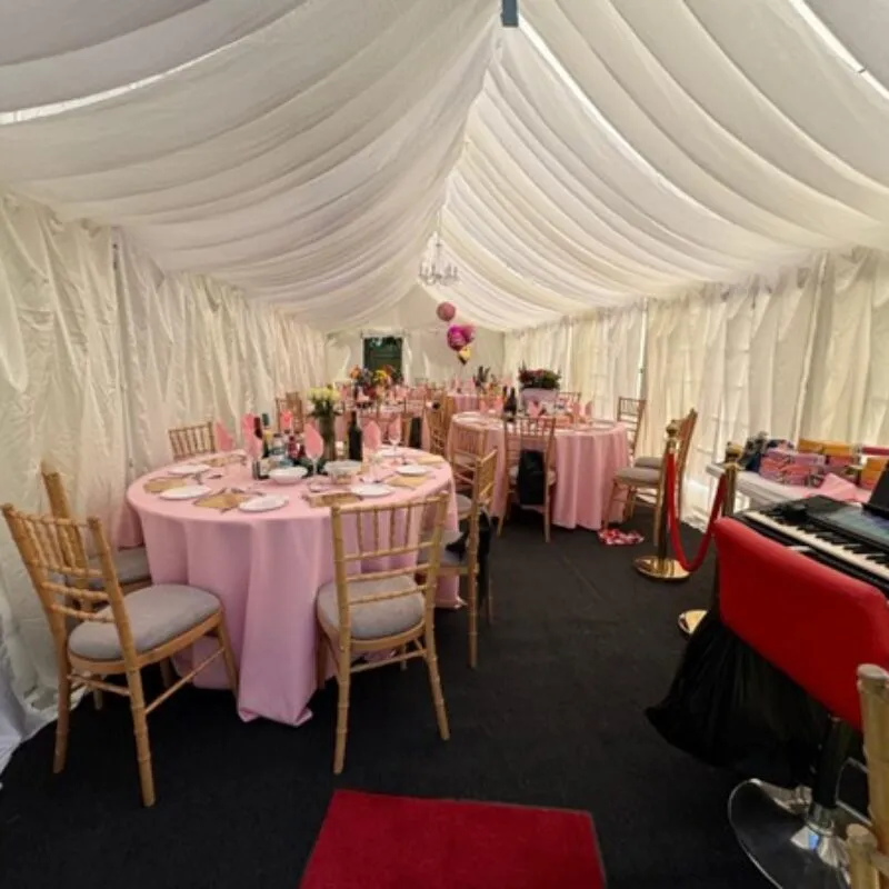 Marquee Interior Dining Setup Hainault Marquee interior with round tables, Chiavari chairs and lighting for birthday celebration in Hainault