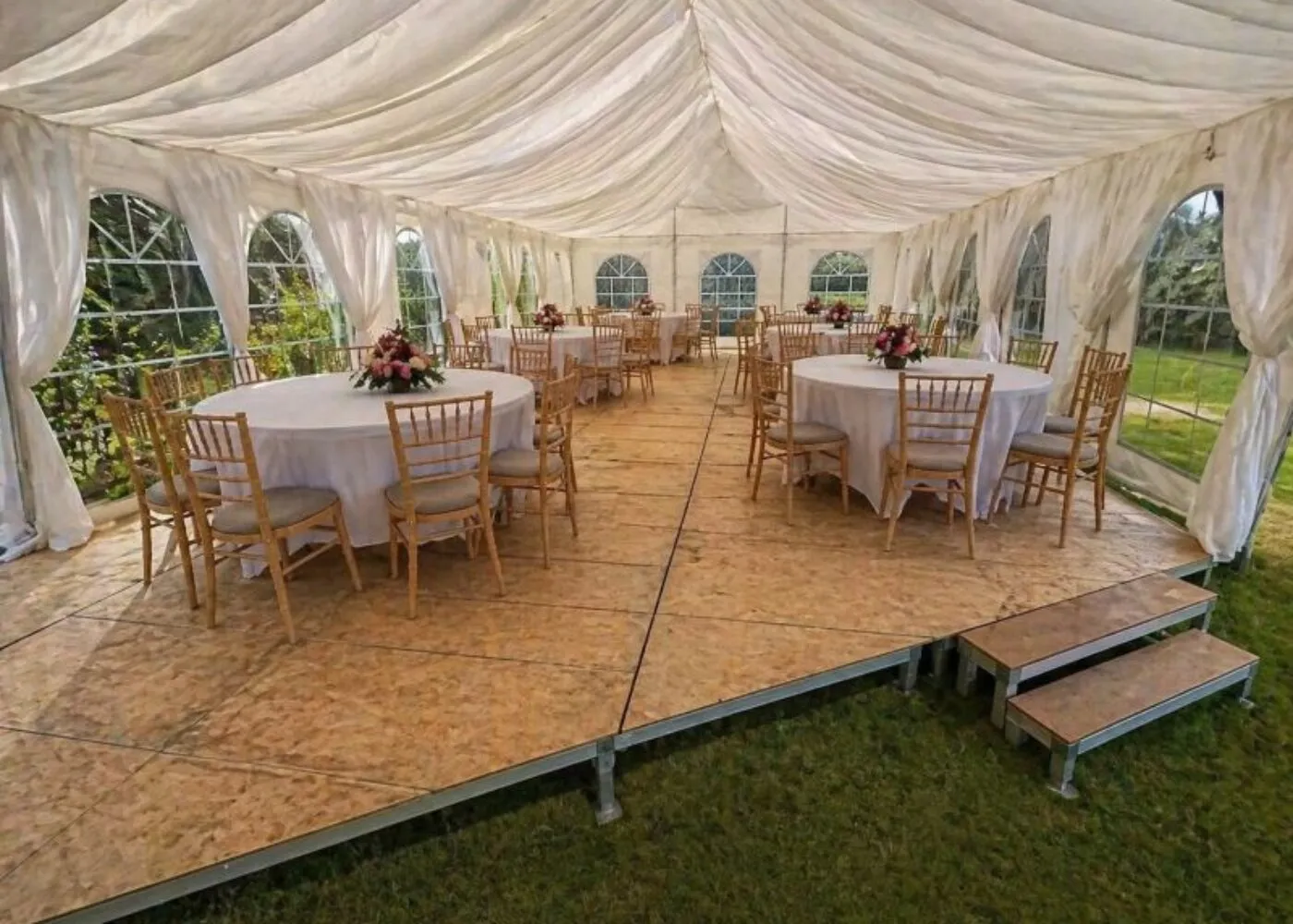 Event furniture setup with round tables and chairs inside a marquee for seated event planning in Essex
