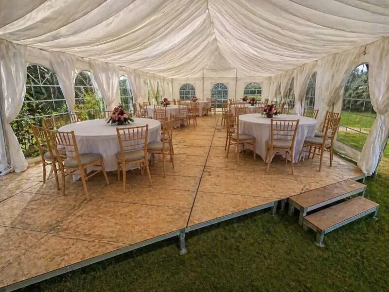 Round tables and chairs inside marquee for event furniture hire in Essex Event furniture setup with round tables and chairs inside a marquee for seated event planning in Essex