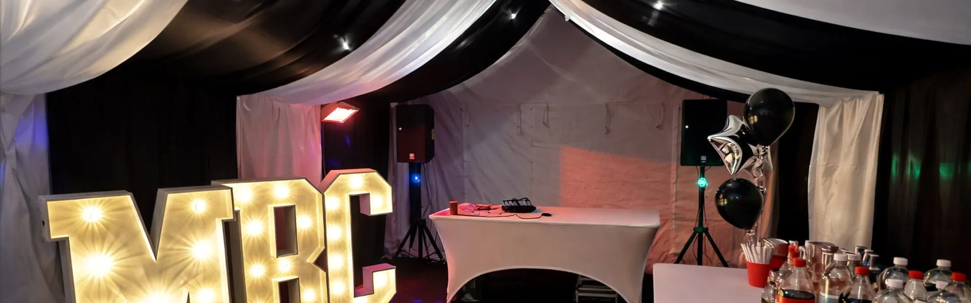 Party Marquee Setup With DJ And Lighting Party marquee interior with DJ booth, lighting and event setup for private celebrations