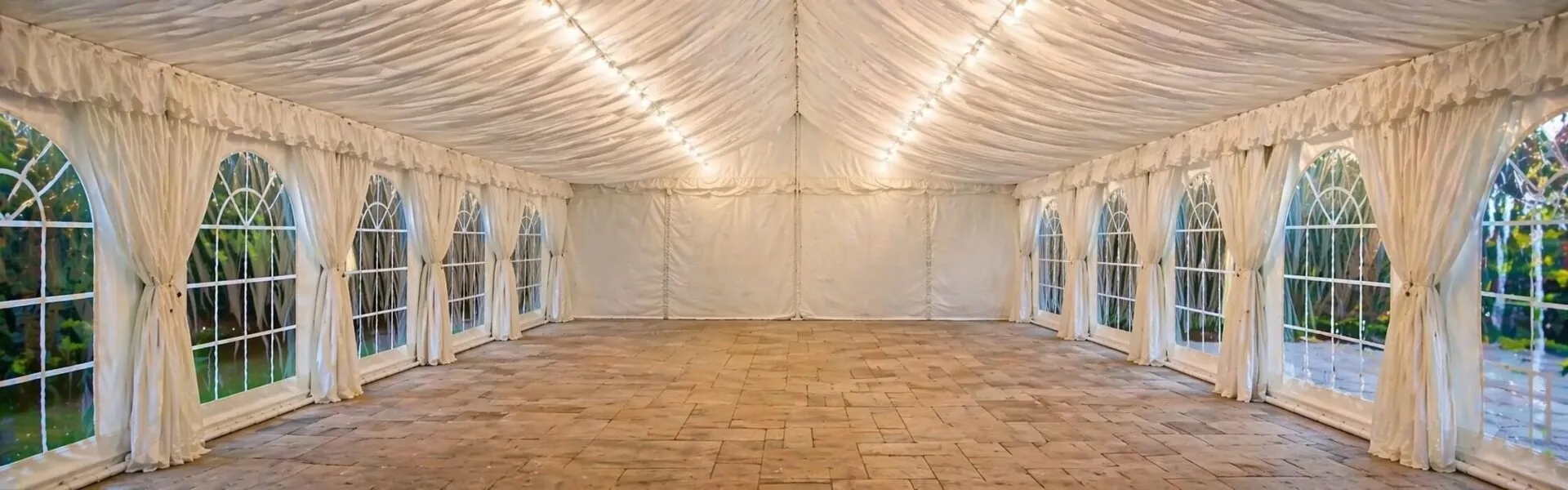Empty Marquee Interior with Draped Ceiling and Lighting Clean empty marquee interior with draped ceiling and soft lighting for event hire