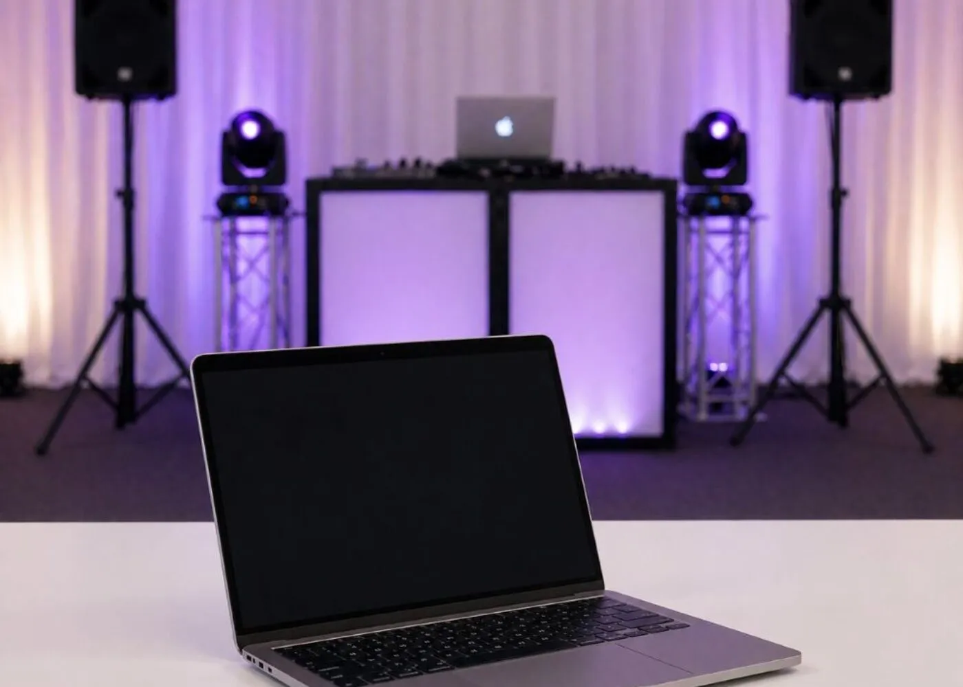 speaker-hire-essex-event-enquiry-setup Speaker and PA system setup in Essex with DJ booth and laptop used for event planning and setup configuration