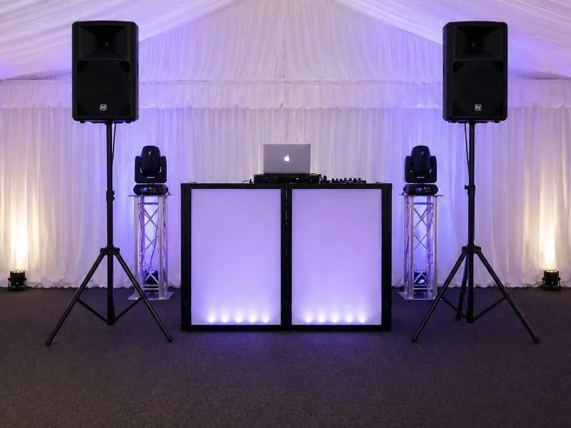 Speaker Hire Essex – Additional Audio Setup and PA System Layout Speaker and PA system setup in Essex with DJ booth and lighting inside marquee showing clean event audio layout