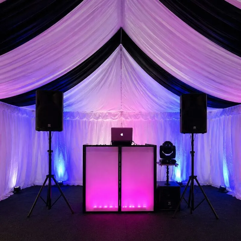 Speaker Setup Essex – DJ Booth & PA System Speaker and PA system setup in Essex with DJ booth and lighting inside marquee event setup