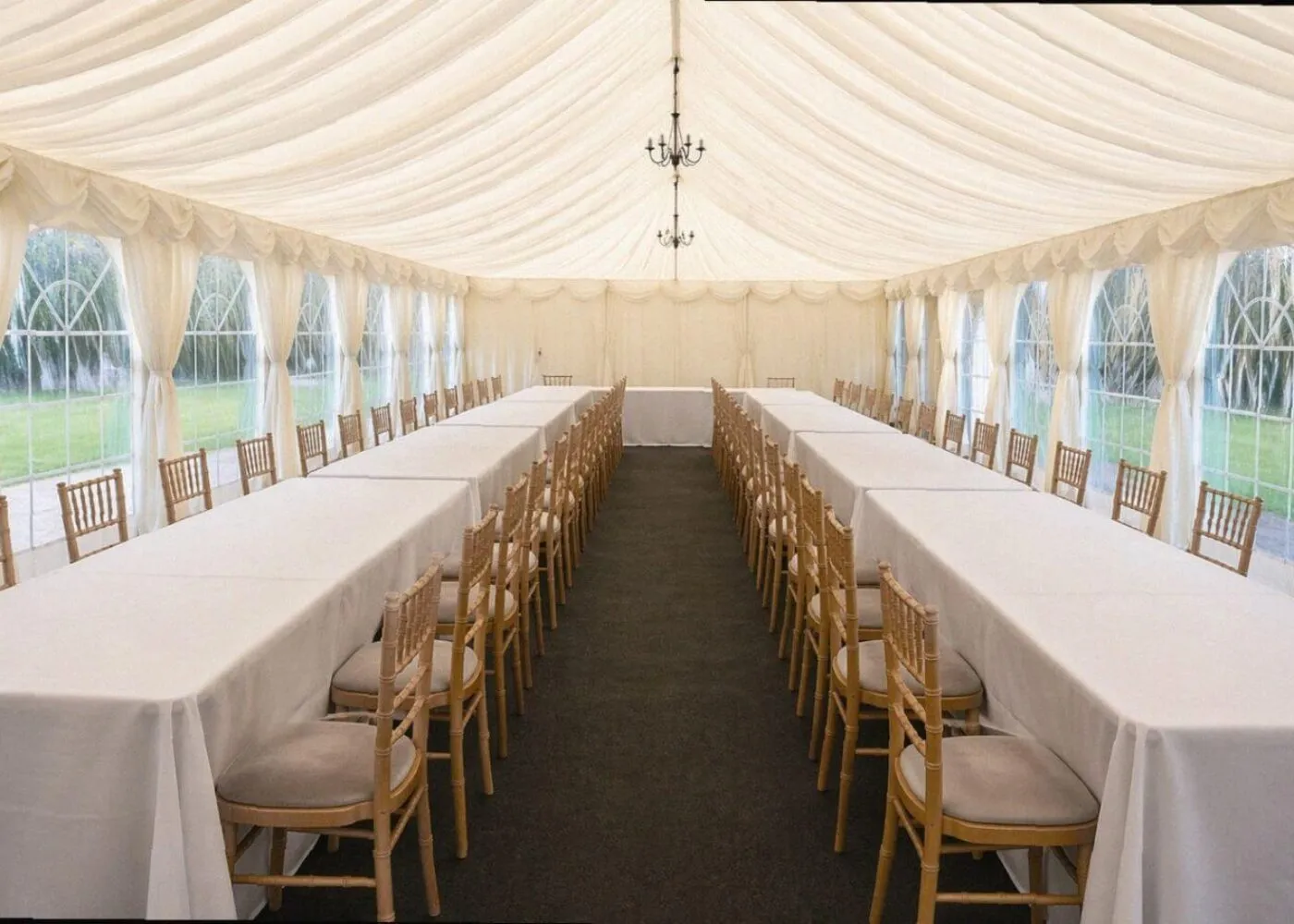 Traditional marquee layout with long tables and chairs showing flexible event setup in Essex
