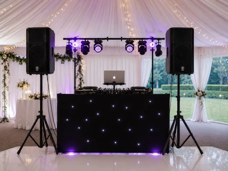 Wedding Marquee DJ Hire Setup Wedding marquee DJ hire setup with PA speakers, DJ decks, lighting bar and starcloth booth