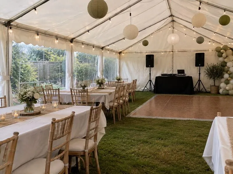 Birthday Garden Marquee with Dining and Dance Area Birthday garden marquee with dining tables, DJ setup and separate dance area