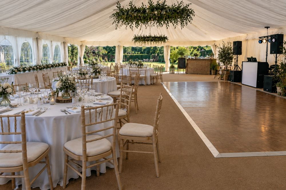 Wedding marquee layout with dining tables and open reception space